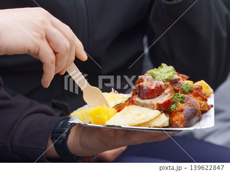Hands holding plate of roasted meat street food in Prague Hands holding plate of roasted meat street food in Prague 139622847