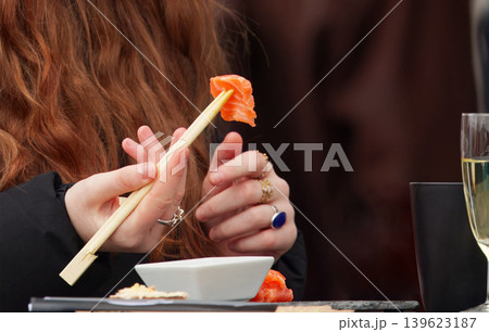 Woman Eating Salmon Sushi with Copy SpaceSalmon Sushi Chopsticks and Copy Space at Market Woman Eating Salmon Sushi with Copy SpaceSalmon Sushi Chopsticks and Copy Space at Market 139623187
