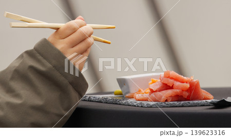 Hand with Chopsticks and Tuna at Naplavka Hand with Chopsticks and Tuna at Naplavka 139623316