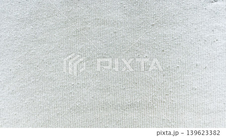 white knitted fabric texture macro revealing soft intricate yarn stitch pattern natural weave cozy loops 139623382
