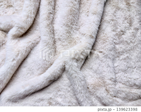 soft plush creamy white faux fur blanket draped with luxurious cozy fluffy texture and elegant macro folds soft plush creamy white faux fur blanket draped with luxurious cozy fluffy texture and elegant macro folds 139623398