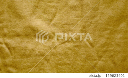wrinkled golden yellow fabric macro texture with intricate folds and deep creases wrinkled golden yellow fabric macro texture with intricate folds and deep creases 139623401