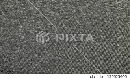 heathered gray cotton jersey knit fabric macro texture with subtle mottled flecks and soft neutral tones filling frame 139623406