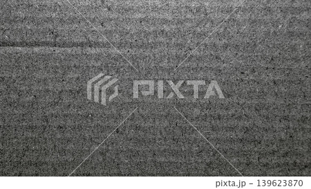 dark asphalt texture macro reveals rough grainy pavement surface with horizontal seam in stark monochrome detail 139623870