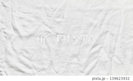 softly crumpled white linen fabric with natural folds and gentle shadows in authentic minimalist tactile texture 139623932