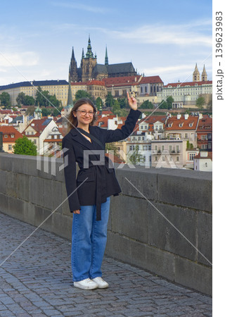 Young tourist pointing at Prague Castle from Charles Bridge Young tourist pointing at Prague Castle from Charles Bridge 139623983