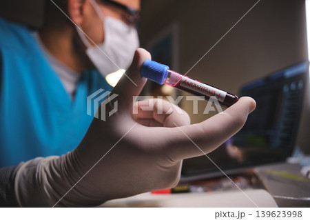 Scientist holding hantavirus positive blood test tube 139623998