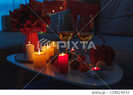 Cozy evening scene with candles, wine glasses and warm candle lighting. 139624032