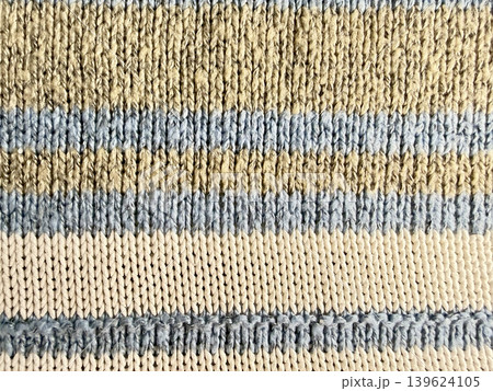 striped ribbed knit cuff texture in beige blue cream wool closeup cozy earthy sustainable fashion fabric detail striped ribbed knit cuff texture in beige blue cream wool closeup cozy earthy sustainable fashion fabric detail 139624105