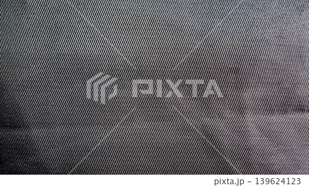 dark woven fabric macro texture with diagonal twill threads and gentle folds revealing tactile depth in moody contrast dark woven fabric macro texture with diagonal twill threads and gentle folds revealing tactile depth in moody contrast 139624123