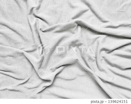 crumpled white linen fabric reveals soft natural folds and intricate texture in serene minimalist closeup detail crumpled white linen fabric reveals soft natural folds and intricate texture in serene minimalist closeup detail 139624151