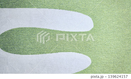 golf course sand bunker curves gracefully amid lush manicured green in peaceful closeup 139624157