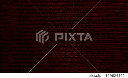 rich dark red corduroy texture closeup captures horizontal ridges in mysterious moody atmosphere 139624163