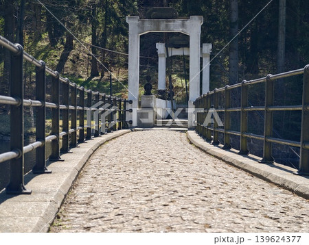 Quiet Pathway Under Towering Arches. Cinematic Shot Of Aged Stones Framing Inviting Passageway Scene 139624377