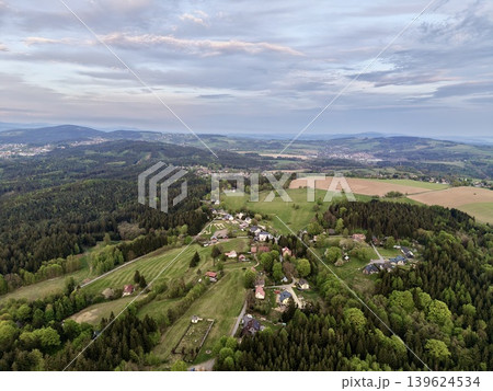 Village At Sunset. Peaceful Hilltop Settlement Showcasing Cultivated Land And Warm Evening Light 139624534