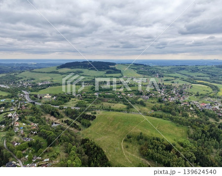 Scattered Communities And Networked Roads Depicted Within Vibrant Hills Under Overcast Sky Scattered Communities And Networked Roads Depicted Within Vibrant Hills Under Overcast Sky 139624540