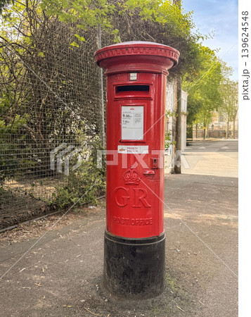 Red British Postbox on City Street Vintage Pillar Mailbox with GR Emblem and Priority Label Red British Postbox on City Street Vintage Pillar Mailbox with GR Emblem and Priority Label 139624548