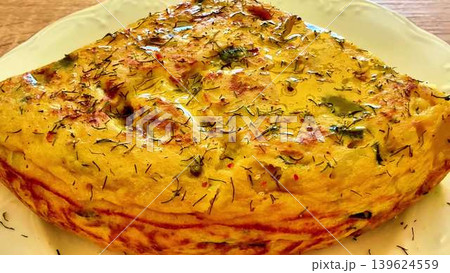 A Delectable and Flavorful Omelette with an Assortment of Fresh Herbs and Colorful Vegetables A Delectable and Flavorful Omelette with an Assortment of Fresh Herbs and Colorful Vegetables 139624559
