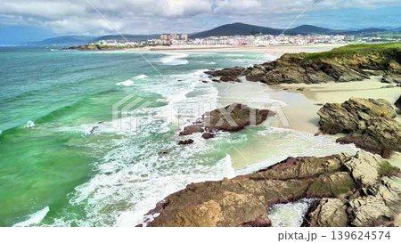 Experience a breathtaking coastal view with stunning waves and inviting sandy beaches Experience a breathtaking coastal view with stunning waves and inviting sandy beaches 139624574