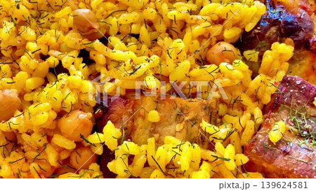 Savor the flavors of Delicious Yellow Rice with Chickpeas and tender Meat, a feast beloved by many 139624581