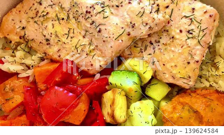 A simply delicious and healthy Salmon Bowl filled with colorful vegetables and fluffy rice A simply delicious and healthy Salmon Bowl filled with colorful vegetables and fluffy rice 139624584