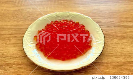 A beautifully arranged plate of fresh red fish caviar, perfect for an elegant dining experience 139624593