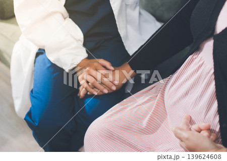 Pregnant woman having her belly examined by a doctor with a stethoscope in a clinic room highlighting a medical checkup, pregnancy health, and prenatal care Pregnant woman having her belly examined by a doctor with a stethoscope in a clinic room highlighting a medical checkup, pregnancy health, and prenatal care 139624608