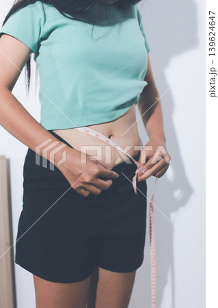 Flabby belly after pregnancy, overweight female body on gray background Flabby belly after pregnancy, overweight female body on gray background 139624647
