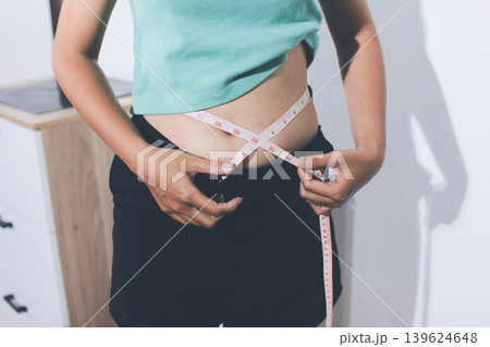Flabby belly after pregnancy, overweight female body on gray background Flabby belly after pregnancy, overweight female body on gray background 139624648