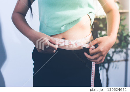 Flabby belly after pregnancy, overweight female body on gray background Flabby belly after pregnancy, overweight female body on gray background 139624652
