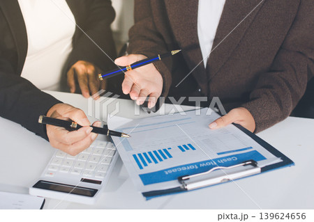 Accountants processing financial documents and taxes, managing corporate finance in a modern office. Audit and taxes in business Accountants processing financial documents and taxes, managing corporate finance in a modern office. Audit and taxes in business 139624656