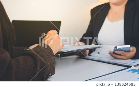 Accountants processing financial documents and taxes, managing corporate finance in a modern office. Audit and taxes in business Accountants processing financial documents and taxes, managing corporate finance in a modern office. Audit and taxes in business 139624683