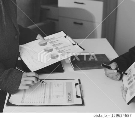 Accountants processing financial documents and taxes, managing corporate finance in a modern office. Audit and taxes in business Accountants processing financial documents and taxes, managing corporate finance in a modern office. Audit and taxes in business 139624687