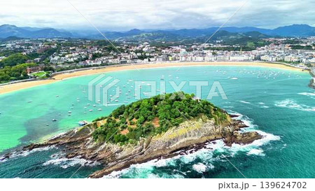 Experience the stunning aerial view of a beautiful coastal island and serene nearby beach 139624702