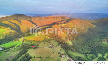 Experience the Breathtaking Aerial View of Scenic Hills and Lush Green Fields During Sunrise Experience the Breathtaking Aerial View of Scenic Hills and Lush Green Fields During Sunrise 139624744