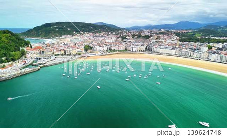 Stunning Aerial View of a Coastal Town with a Beautiful Bay and Boats Floating in the Water Stunning Aerial View of a Coastal Town with a Beautiful Bay and Boats Floating in the Water 139624748