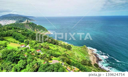 A breathtaking scenic coastal view showcasing lush green hills alongside a beautiful ocean A breathtaking scenic coastal view showcasing lush green hills alongside a beautiful ocean 139624754