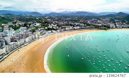 Stunning Aerial View of a Coastal Beach with Turquoise Waters and a Charming Town Stunning Aerial View of a Coastal Beach with Turquoise Waters and a Charming Town 139624767