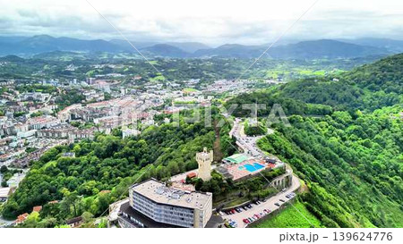 Stunning Aerial View Highlighting the Lush Green Hills Coupled with a Dazzling Cityscape Stunning Aerial View Highlighting the Lush Green Hills Coupled with a Dazzling Cityscape 139624776