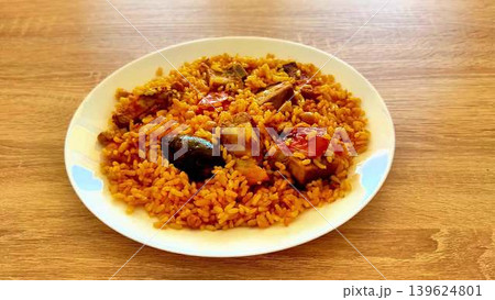 Enjoy the delicious Nigerian Jollof Rice with chicken and fresh vegetables, a cultural delight Enjoy the delicious Nigerian Jollof Rice with chicken and fresh vegetables, a cultural delight 139624801