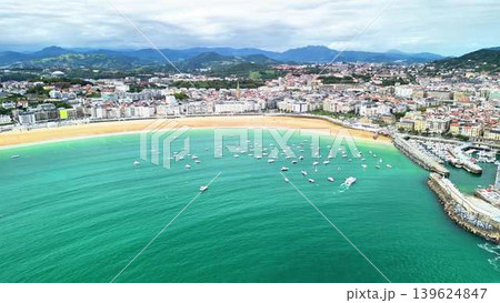 A Stunning Aerial View of a Beautiful Coastal Town Featuring Vibrant Waters and Many Boats 139624847