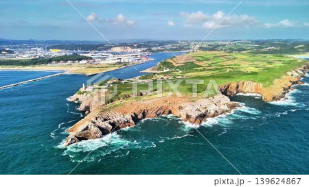 A breathtaking aerial view showcasing the stunning coastal landscape along with an industrial area A breathtaking aerial view showcasing the stunning coastal landscape along with an industrial area 139624867