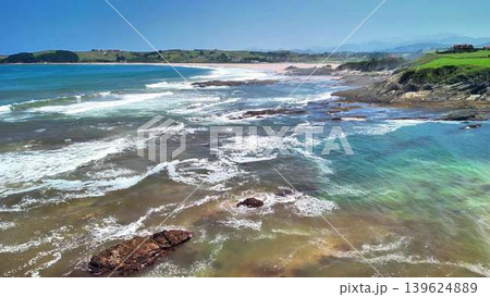 Experience the stunning coastal view with majestic waves crashing on a gorgeous rocky shore Experience the stunning coastal view with majestic waves crashing on a gorgeous rocky shore 139624889