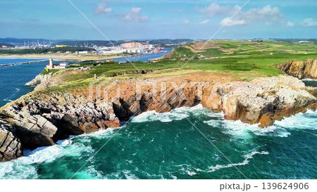A breathtaking and stunning aerial view of a rocky shoreline alongside crashing ocean waves 139624906