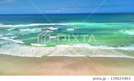 A Beautiful and Tranquil Beach Scene Featuring Gentle Waves and Clear Blue Skies Above A Beautiful and Tranquil Beach Scene Featuring Gentle Waves and Clear Blue Skies Above 139624963