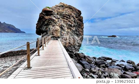 Enjoy a stunning coastal view with a charming promenade and rocky outcrop, simply breathtaking Enjoy a stunning coastal view with a charming promenade and rocky outcrop, simply breathtaking 139625021