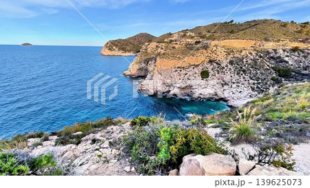A Serene Coastal Landscape Featuring Clear Blue Waters, Scenic Rocky Cliffs, and Natures Wonder A Serene Coastal Landscape Featuring Clear Blue Waters, Scenic Rocky Cliffs, and Natures Wonder 139625073