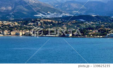 Experience the breathtaking scenic coastal view that features a stunning mountain backdrop Experience the breathtaking scenic coastal view that features a stunning mountain backdrop 139625235