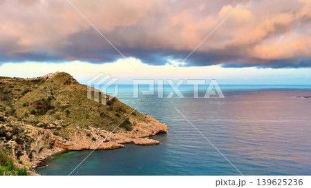Experience the serene coastal sunset with soft cloud reflections, truly captivating Experience the serene coastal sunset with soft cloud reflections, truly captivating 139625236
