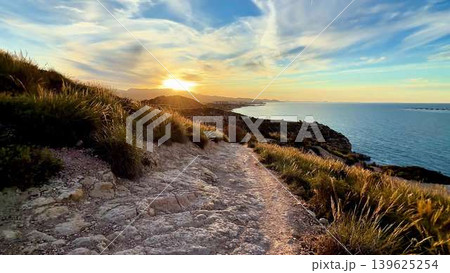 Experience a Serene Coastal Sunset A Scenic Path to Explore by the Beautiful Ocean 139625254
